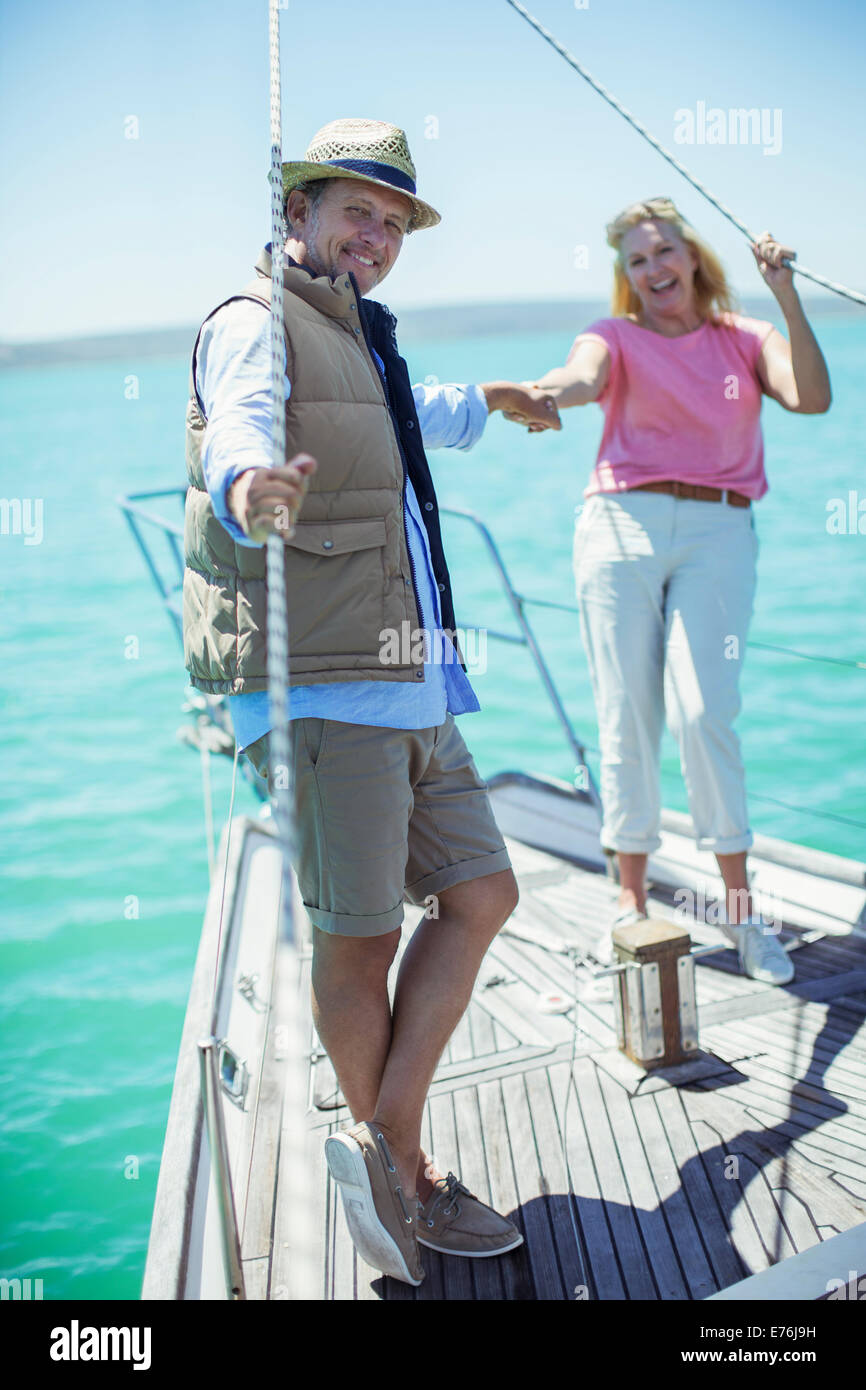 Couple holding hands on boat Stock Photo