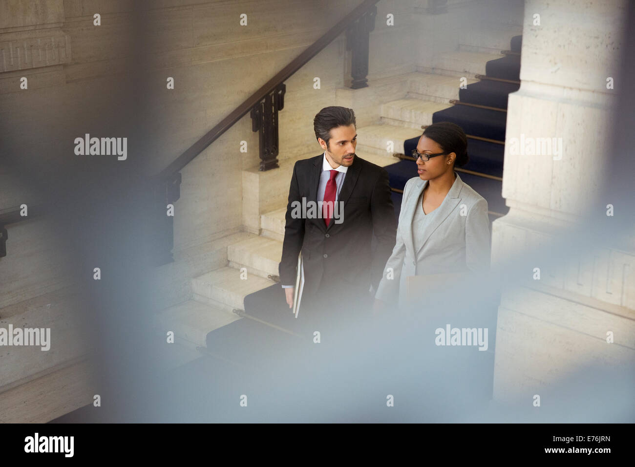 Lawyers walking downstairs in courthouse Stock Photo