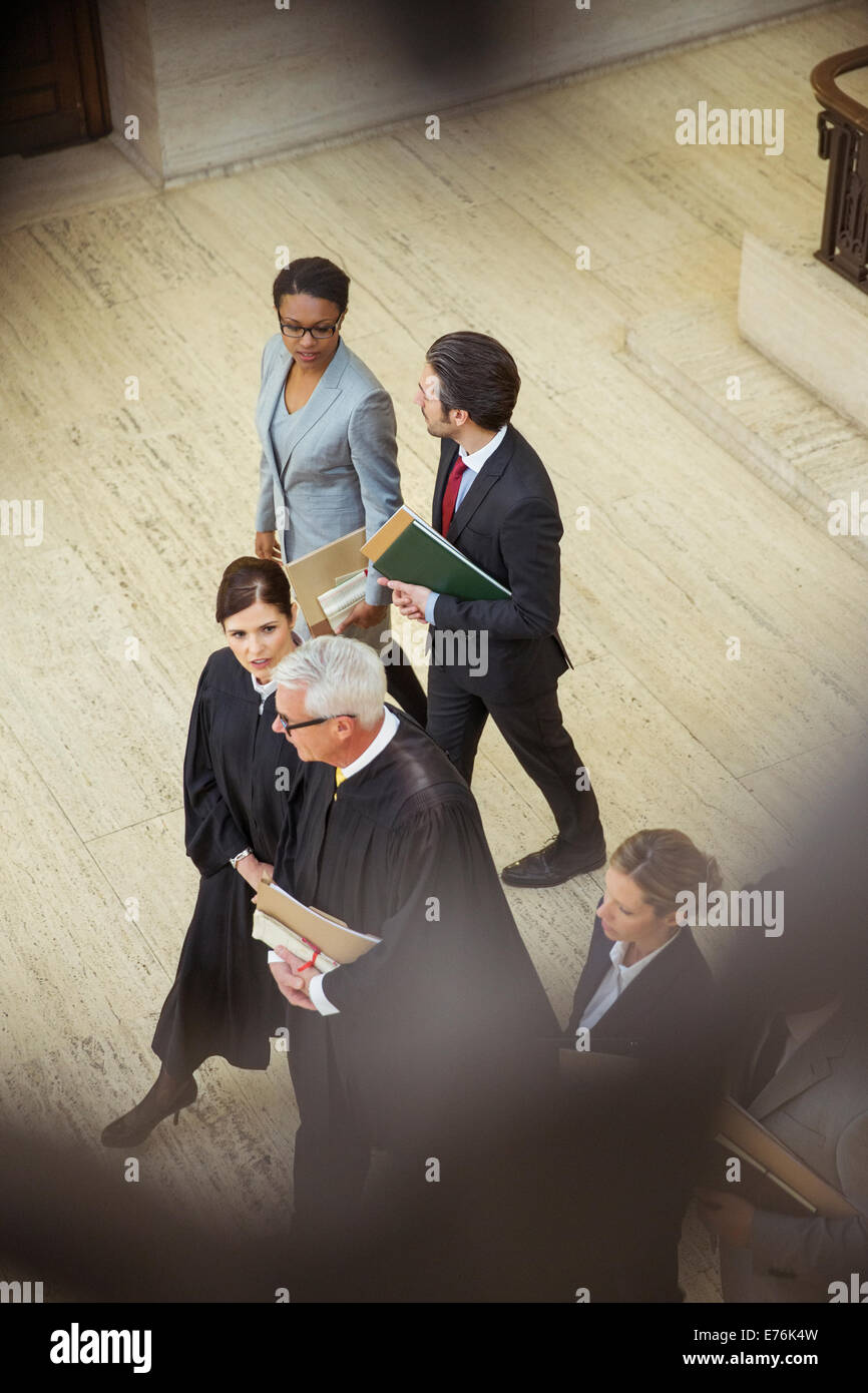 Judges and lawyers walking together in courthouse Stock Photo