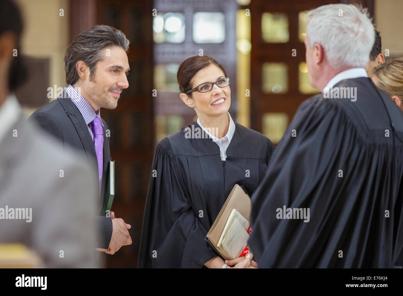 Judges and lawyers talking outside courtroom Stock Photo
