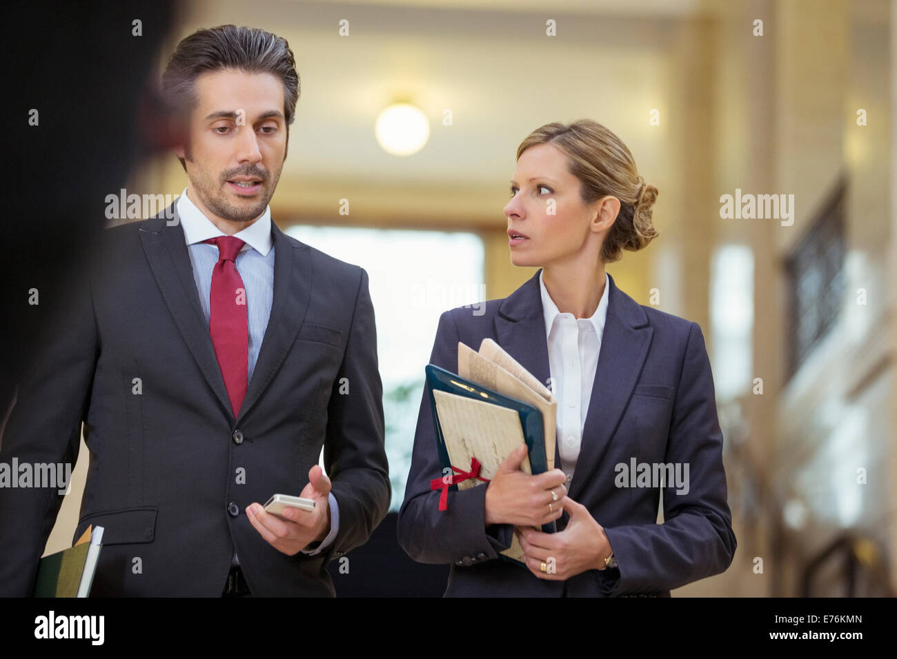 Lawyers walking together through courthouse Stock Photo