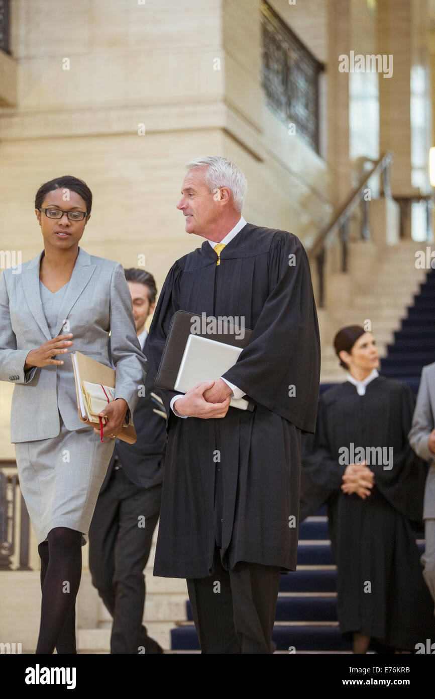 Judge and lawyer walking together through courthouse Stock Photo