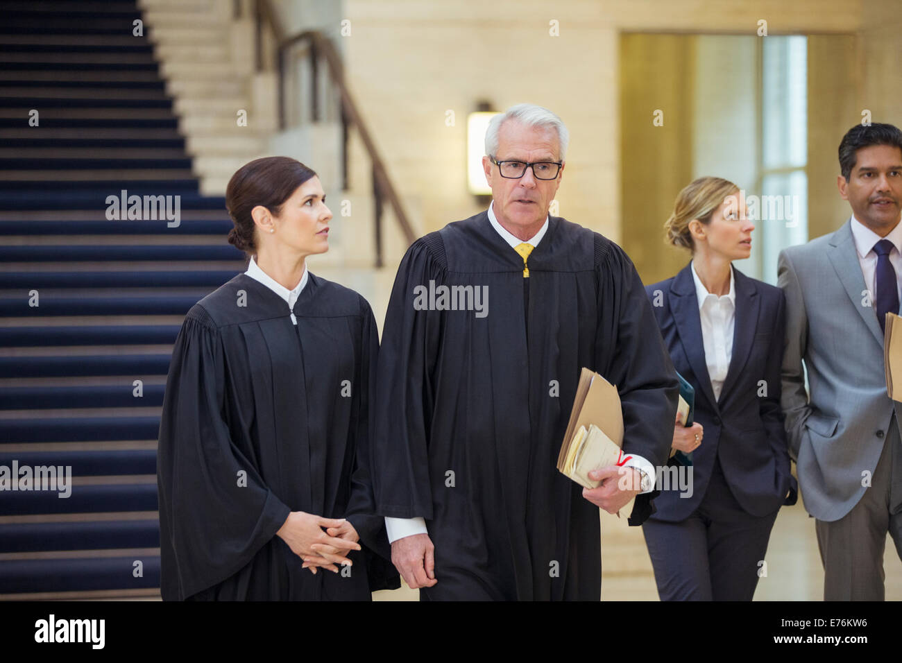 Judges and lawyers walking through courthouse Stock Photo