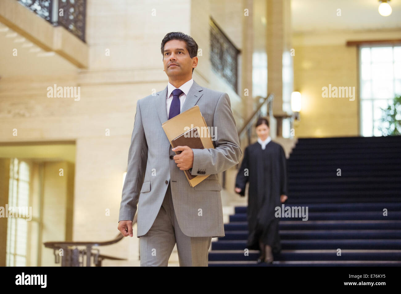 Lawyer walking through courthouse Stock Photo