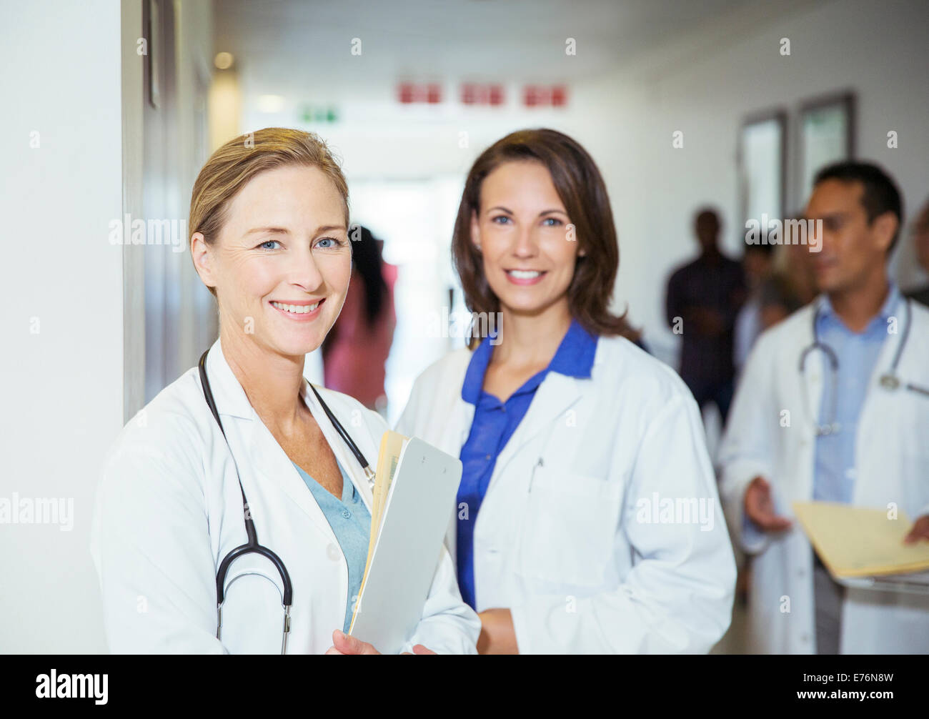 Doctors smiling in hospital hallway Stock Photo