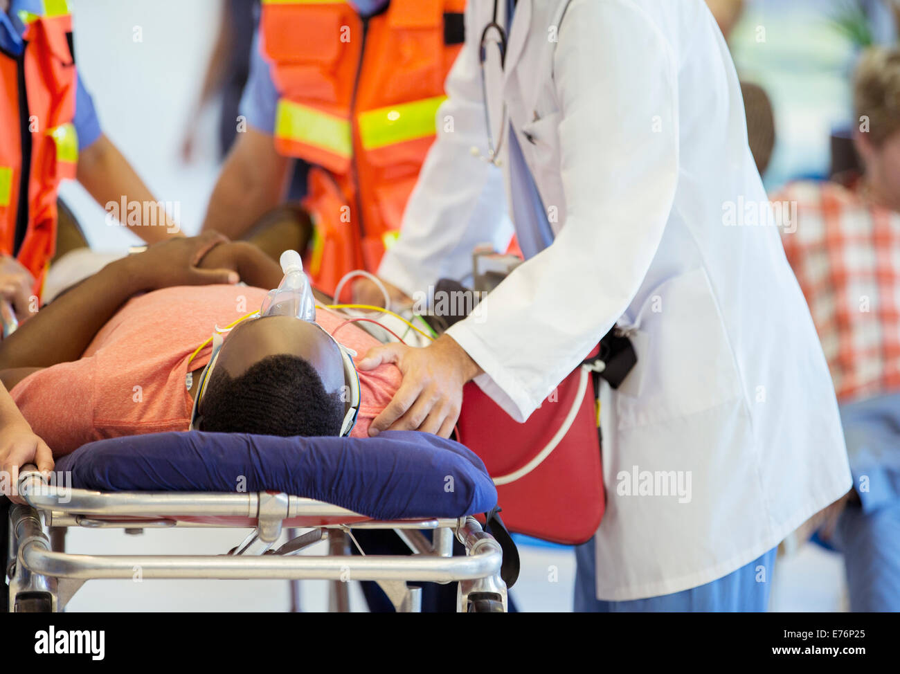 Doctor examining patient on stretcher Stock Photo
