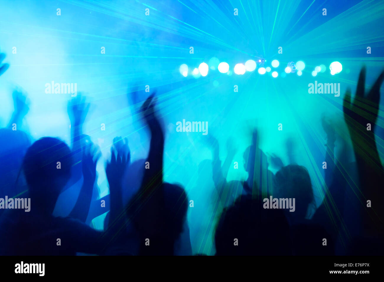 People silhouettes dancing to the disco beat. Stock Photo