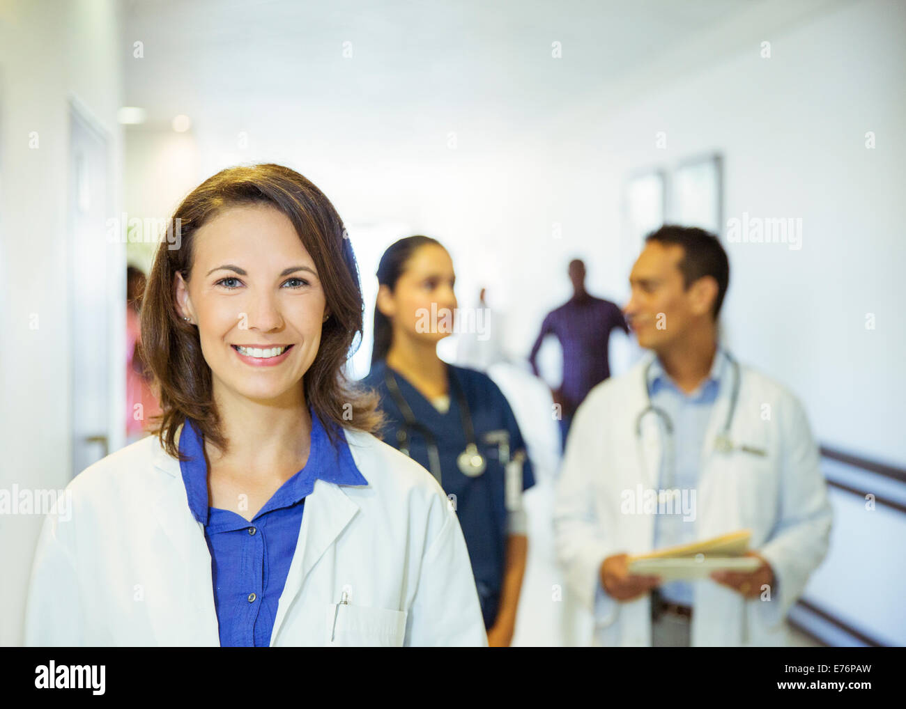 Doctor smiling in hospital hallway Stock Photo