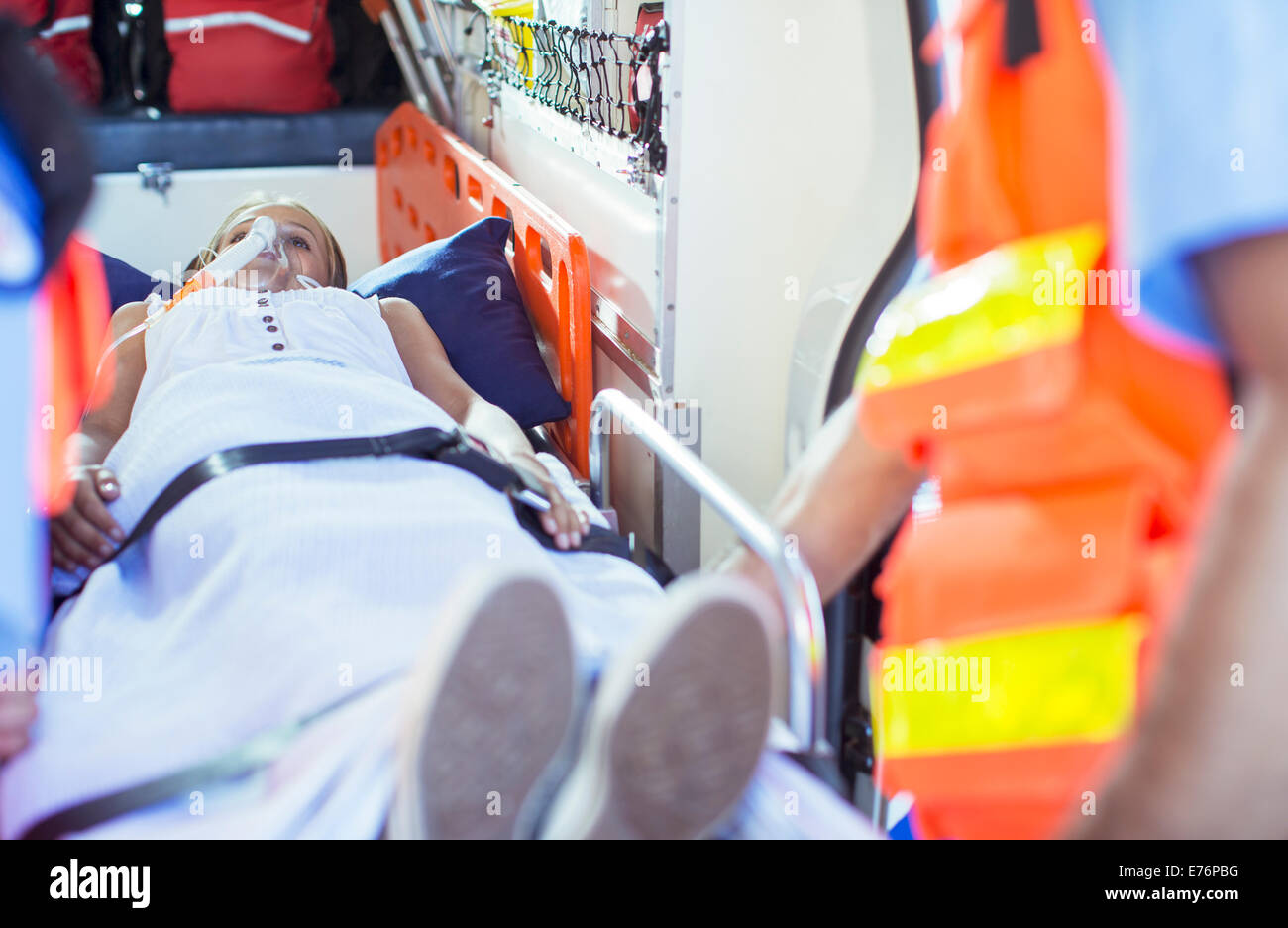 Paramedics examining patient on stretcher in ambulance Stock Photo Alamy