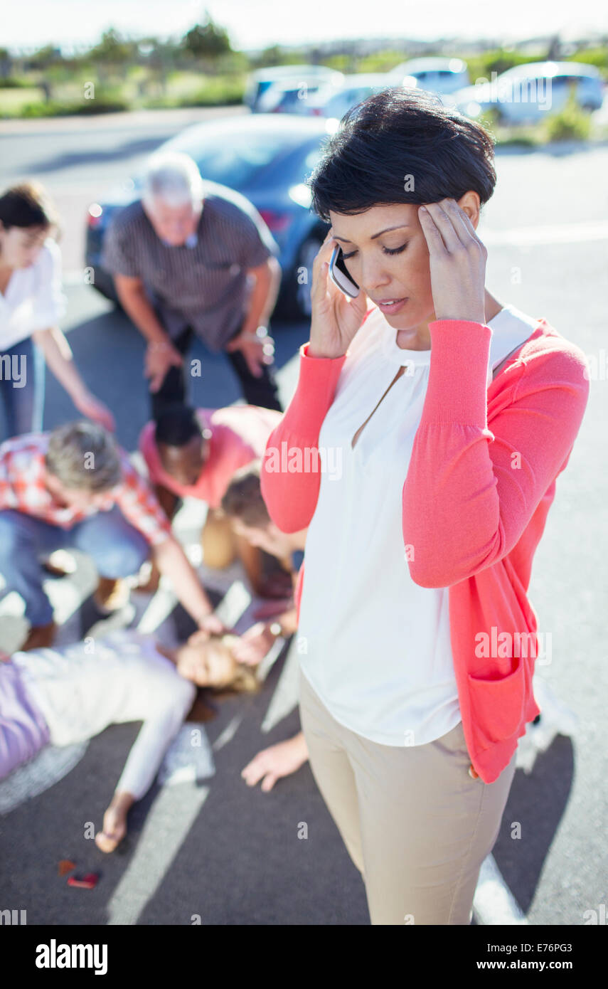 Woman calling emergency services at car accident Stock Photo