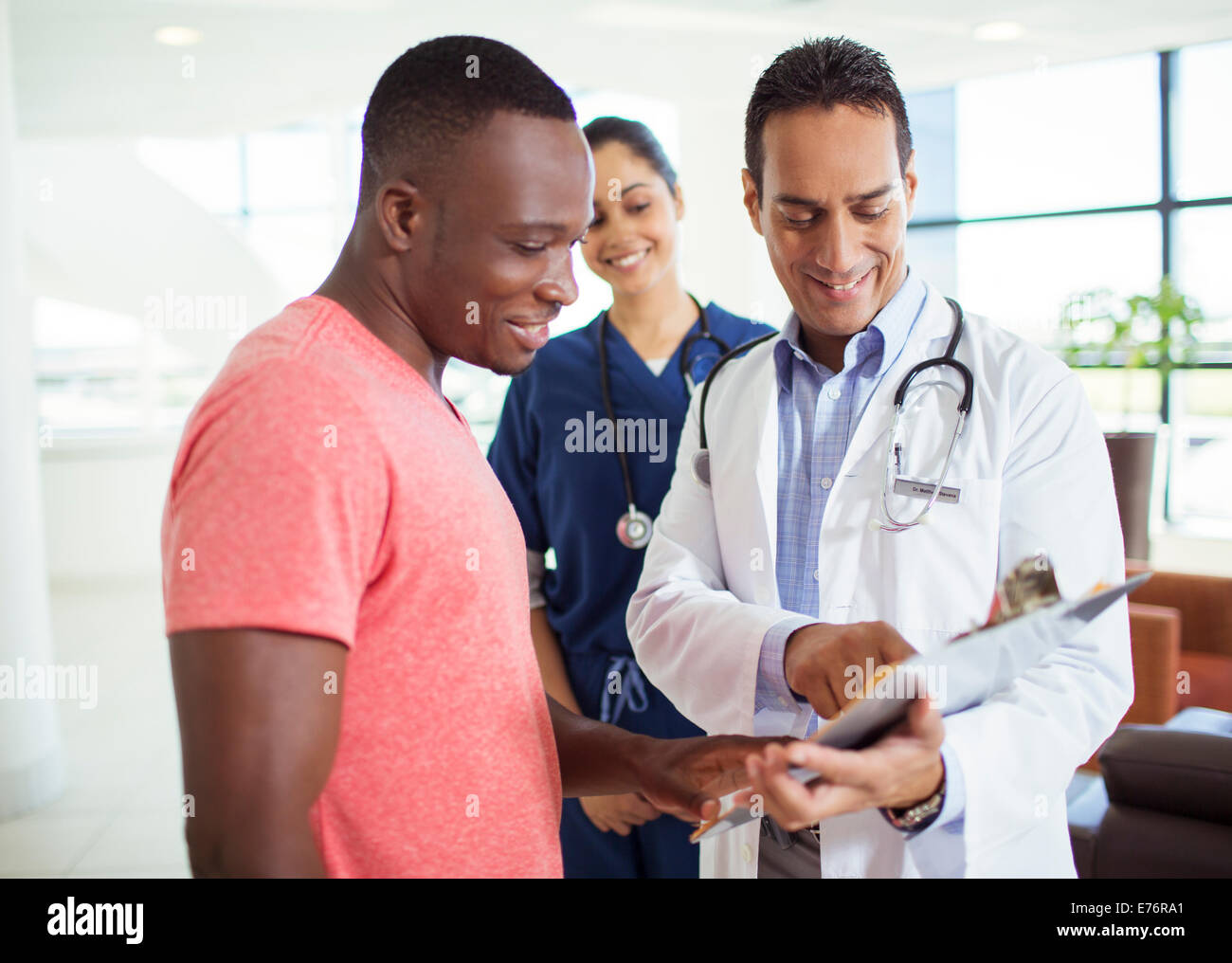 Doctor and patient reading medical chart in hospital Stock Photo
