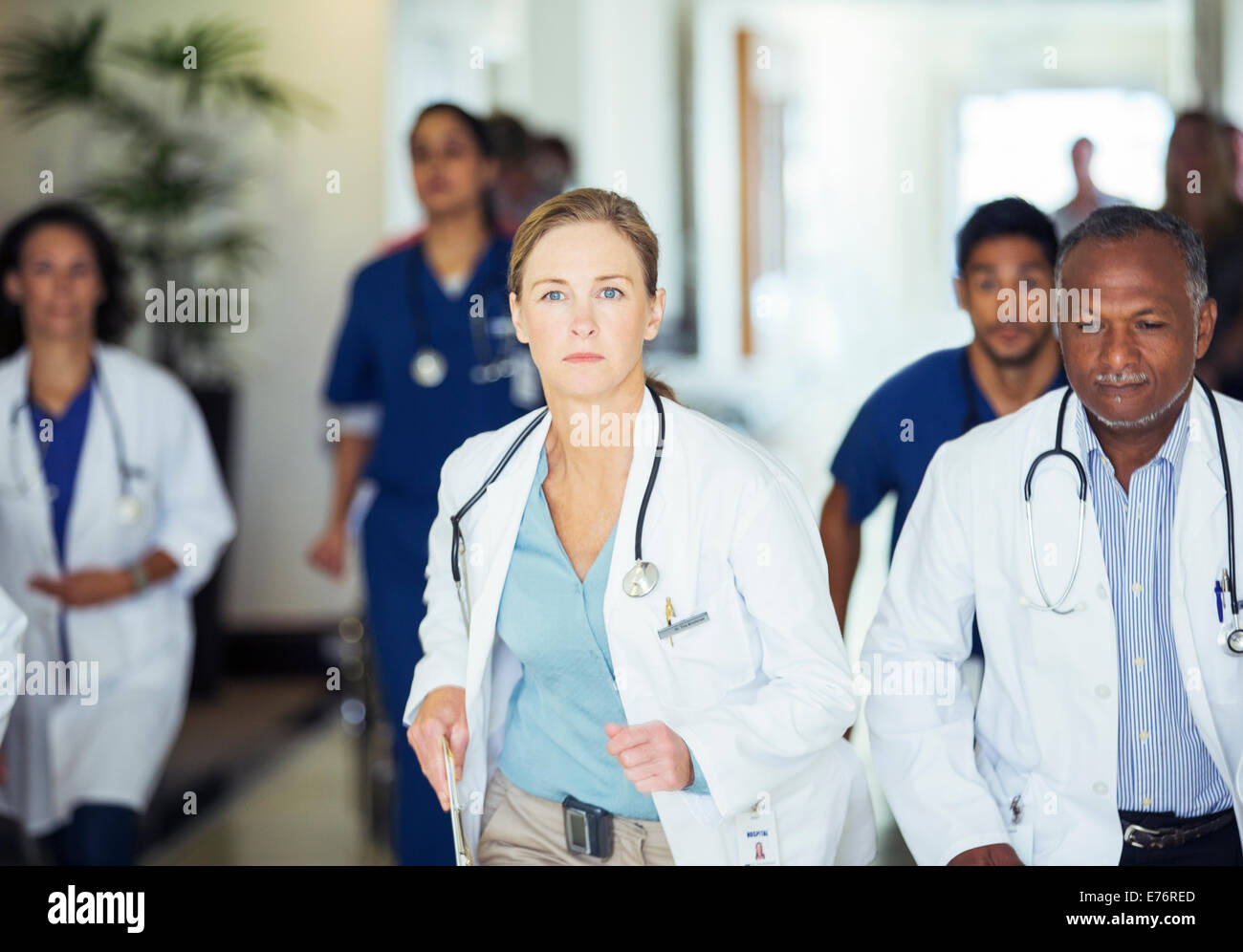 Doctors rushing in hospital hallway Stock Photo
