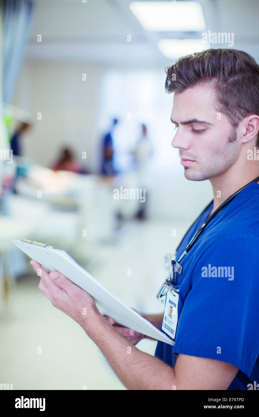 Nurse reading medical chart in hospital Stock Photo