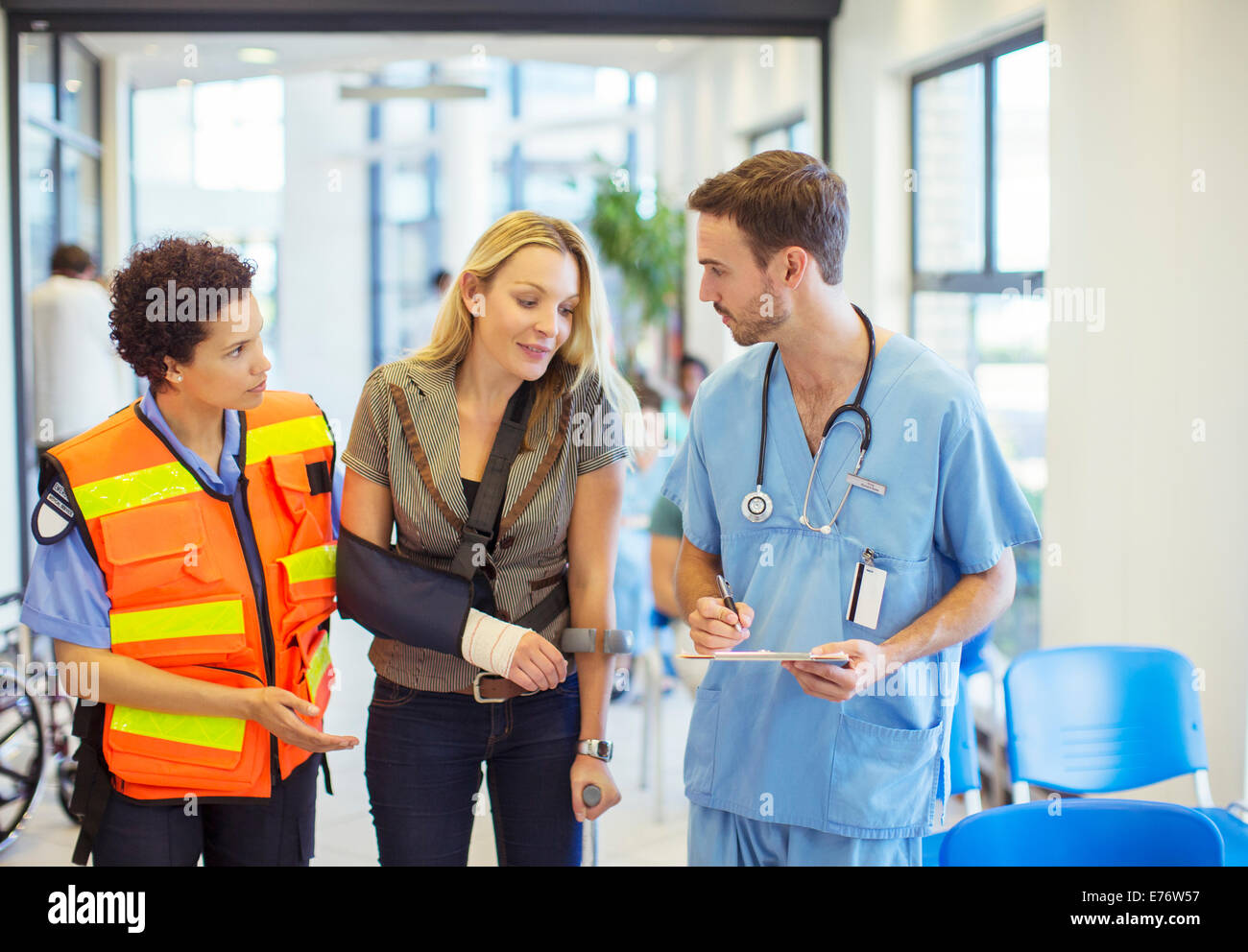 Nurse and paramedic talking to patient in hospital Stock Photo