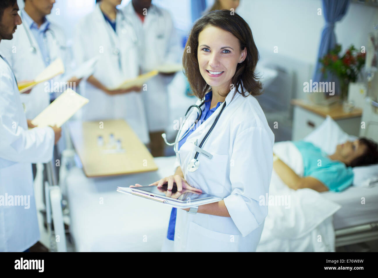 Doctor using digital tablet in hospital room Stock Photo