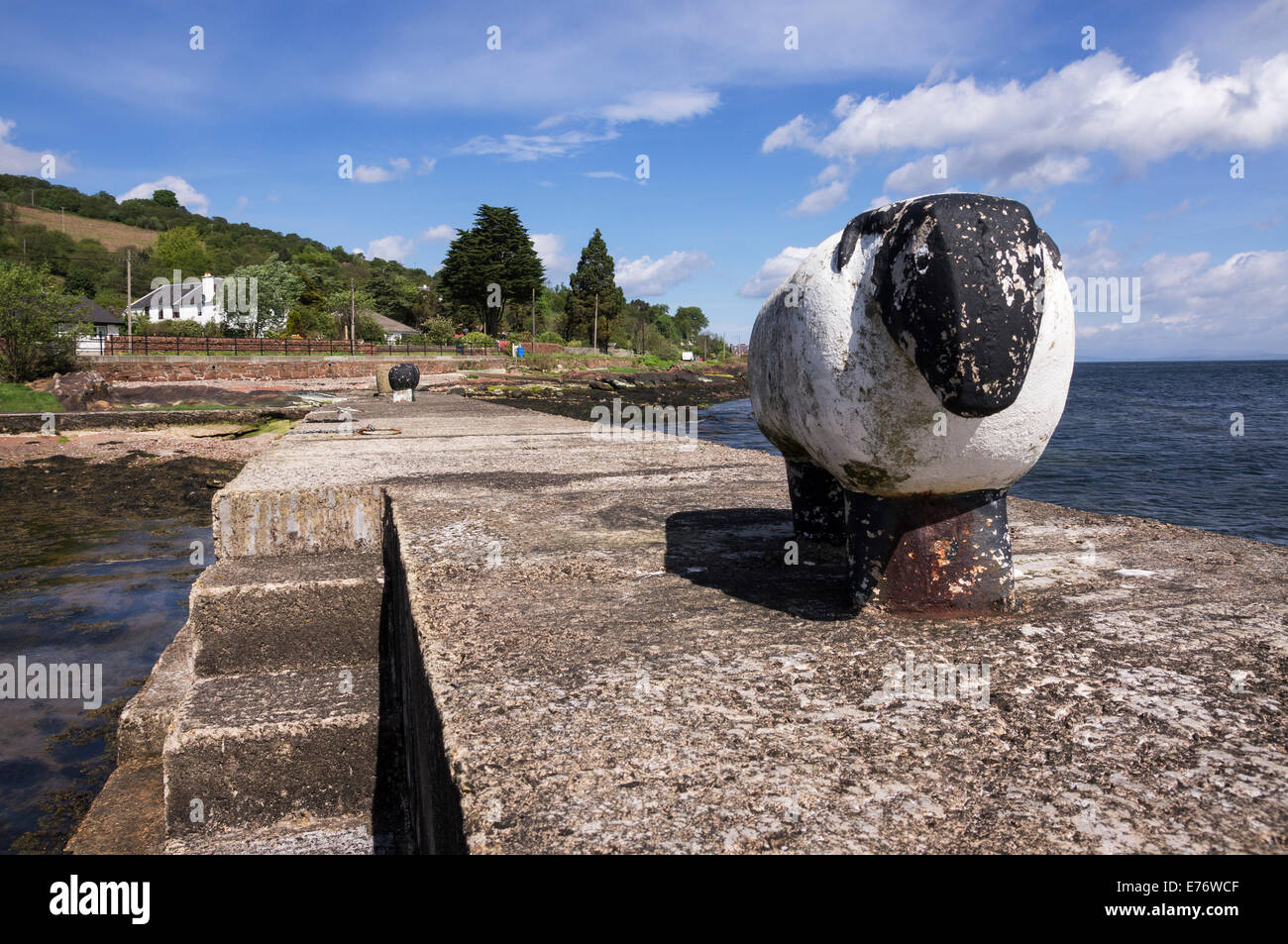 Unusual moorings in the shape of sheep on the harbour wall at Corrie, Isle of Arran. Stock Photo