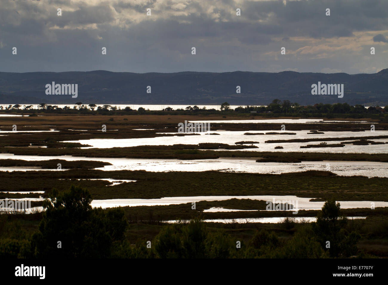 View across salt marshes in stormy weather. From Ile St. Martin towards  L'étang de Bages-Sigean. Aude, France. May. Stock Photo
