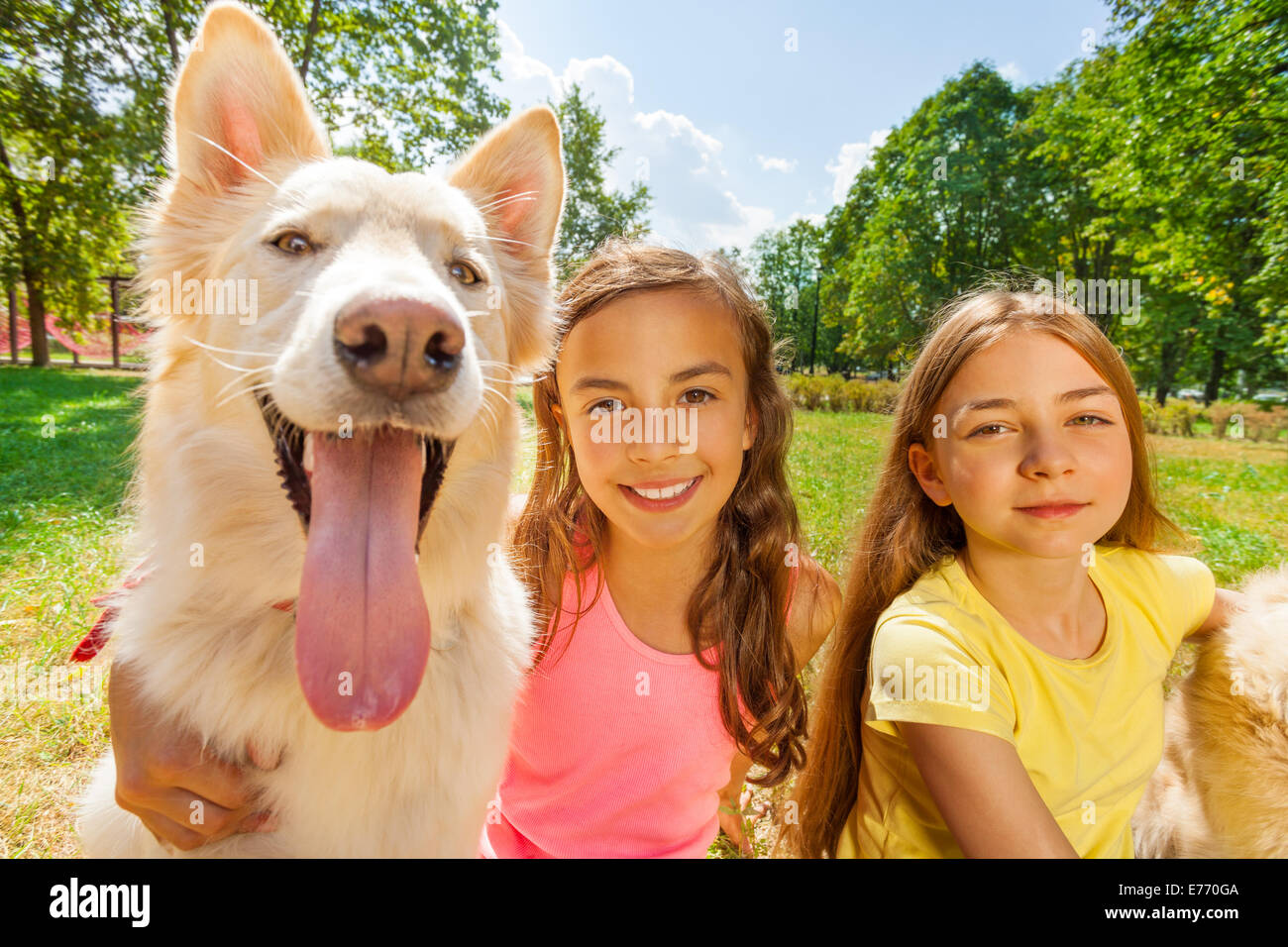 Couple happy girls with funny dog Stock Photo