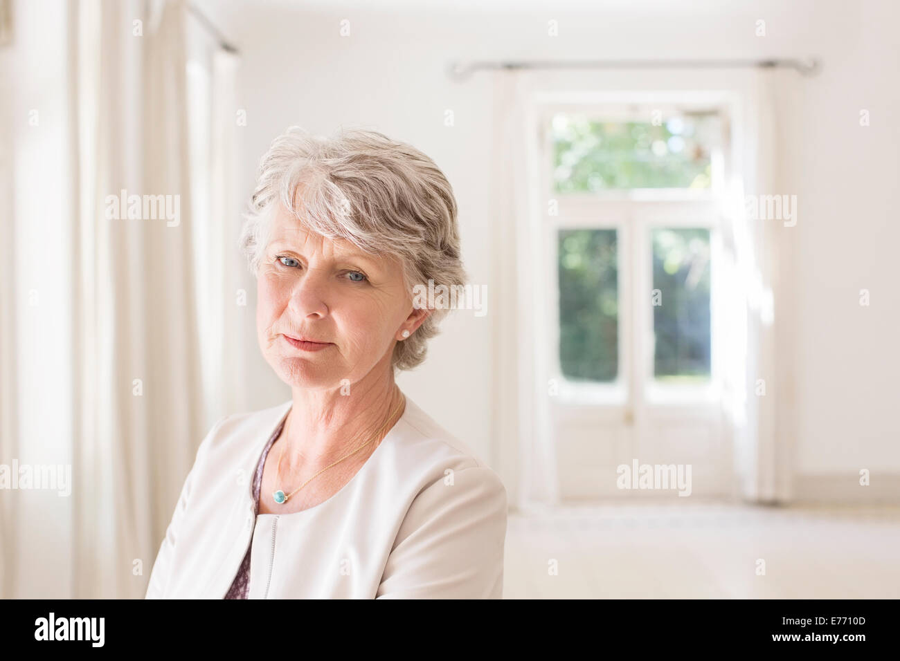 Older woman in empty living room Stock Photo