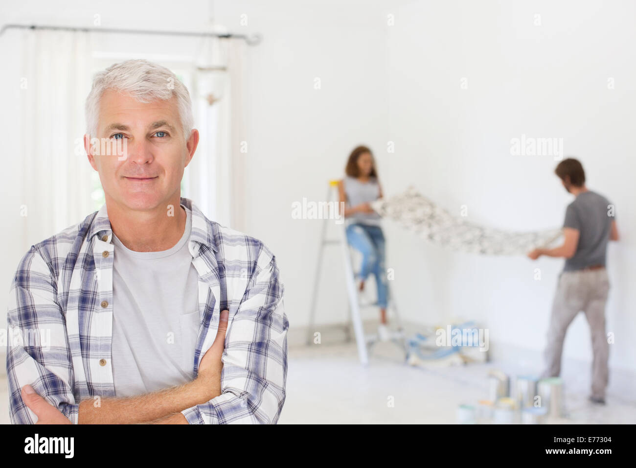 Older man smiling with family working Stock Photo