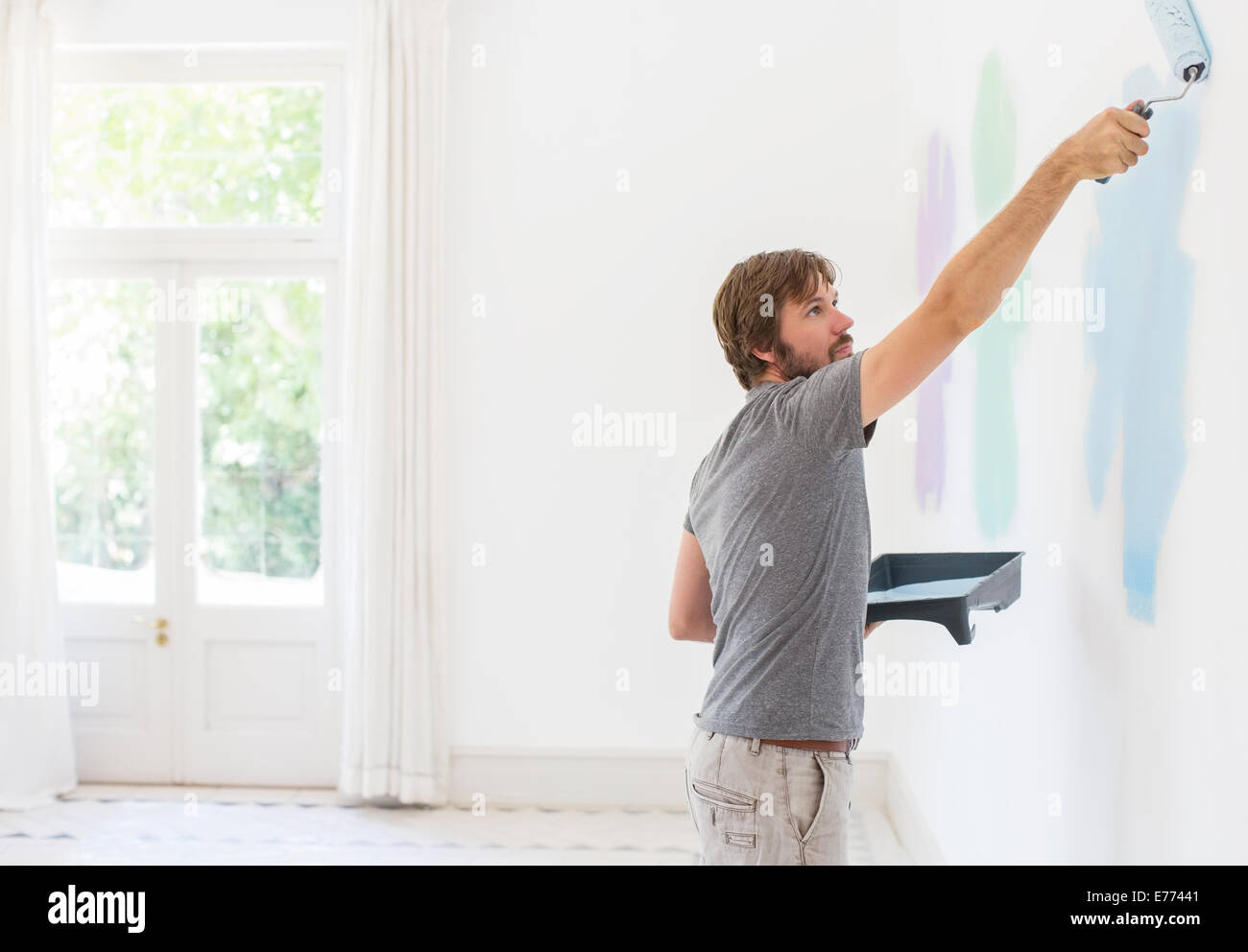 Man painting wall in living space Stock Photo