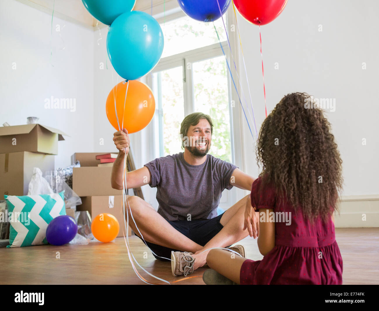 Father and daughter playing with balloons Stock Photo