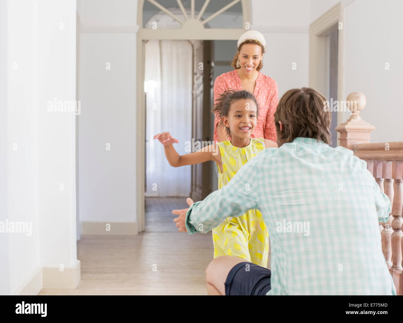 Father and daughter embracing in living space Stock Photo