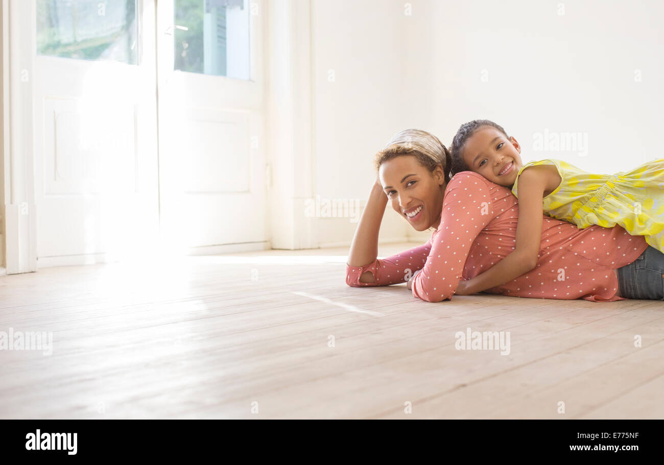 Mother and daughter relaxing in living space Stock Photo