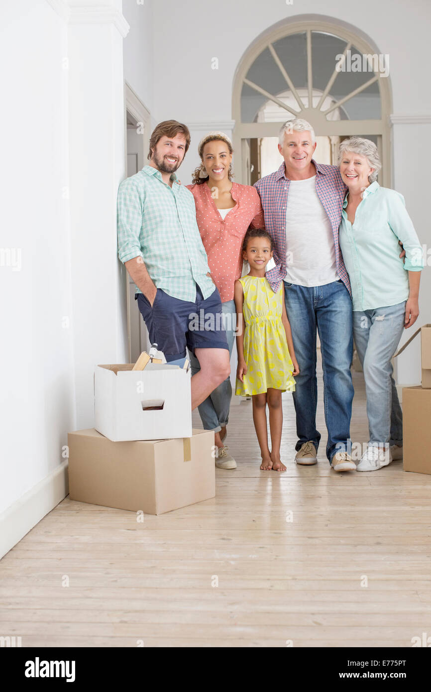 Family smiling together in living space Stock Photo