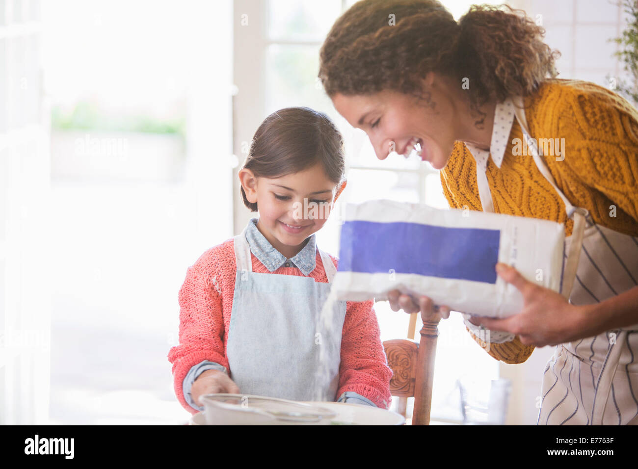 Mother and daughter baking together Stock Photo