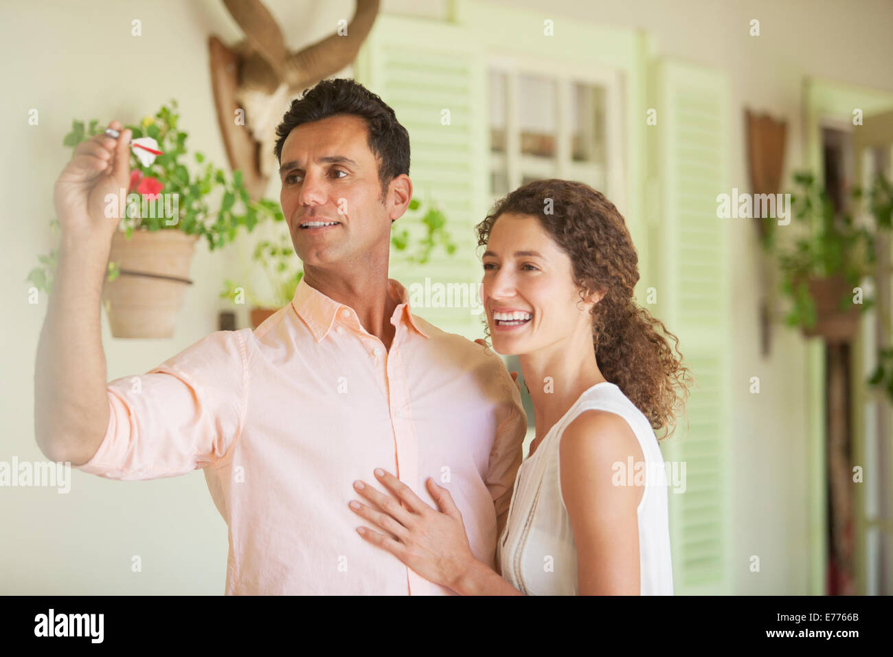 Couple playing darts game together Stock Photo
