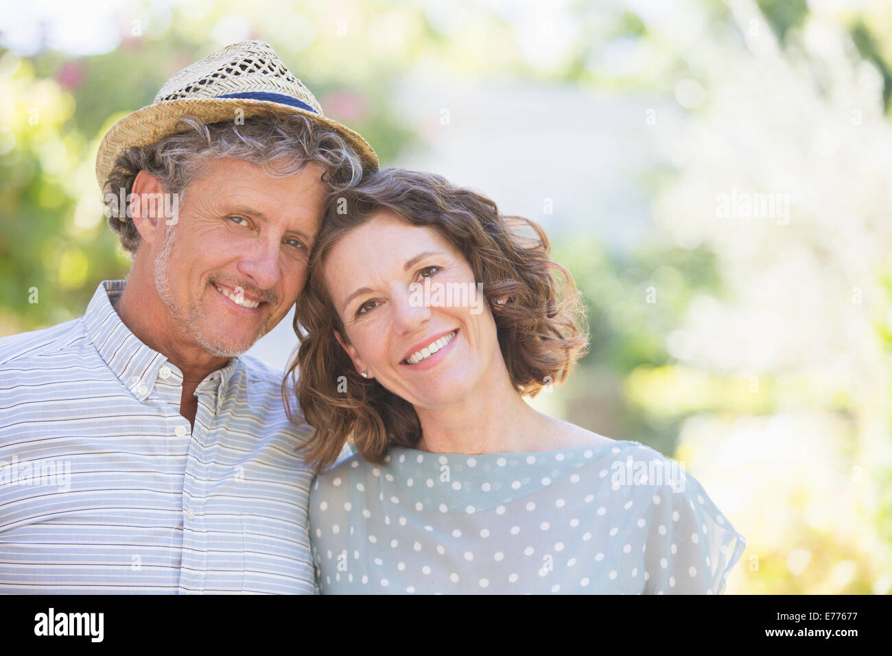 Older couple hugging outdoors Stock Photo