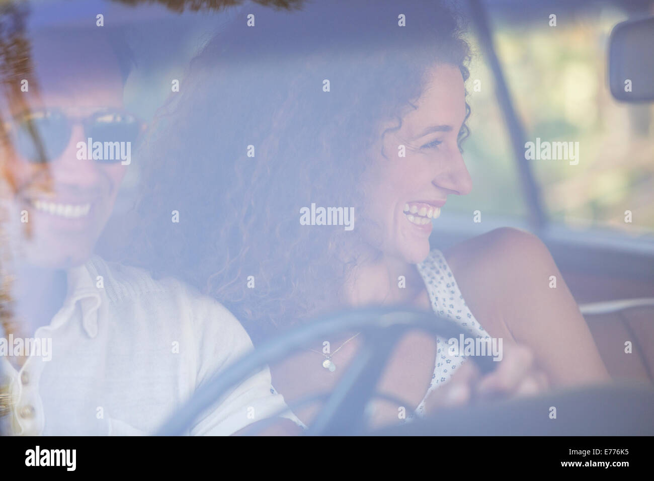 Couple enjoying car ride together on sunny day Stock Photo