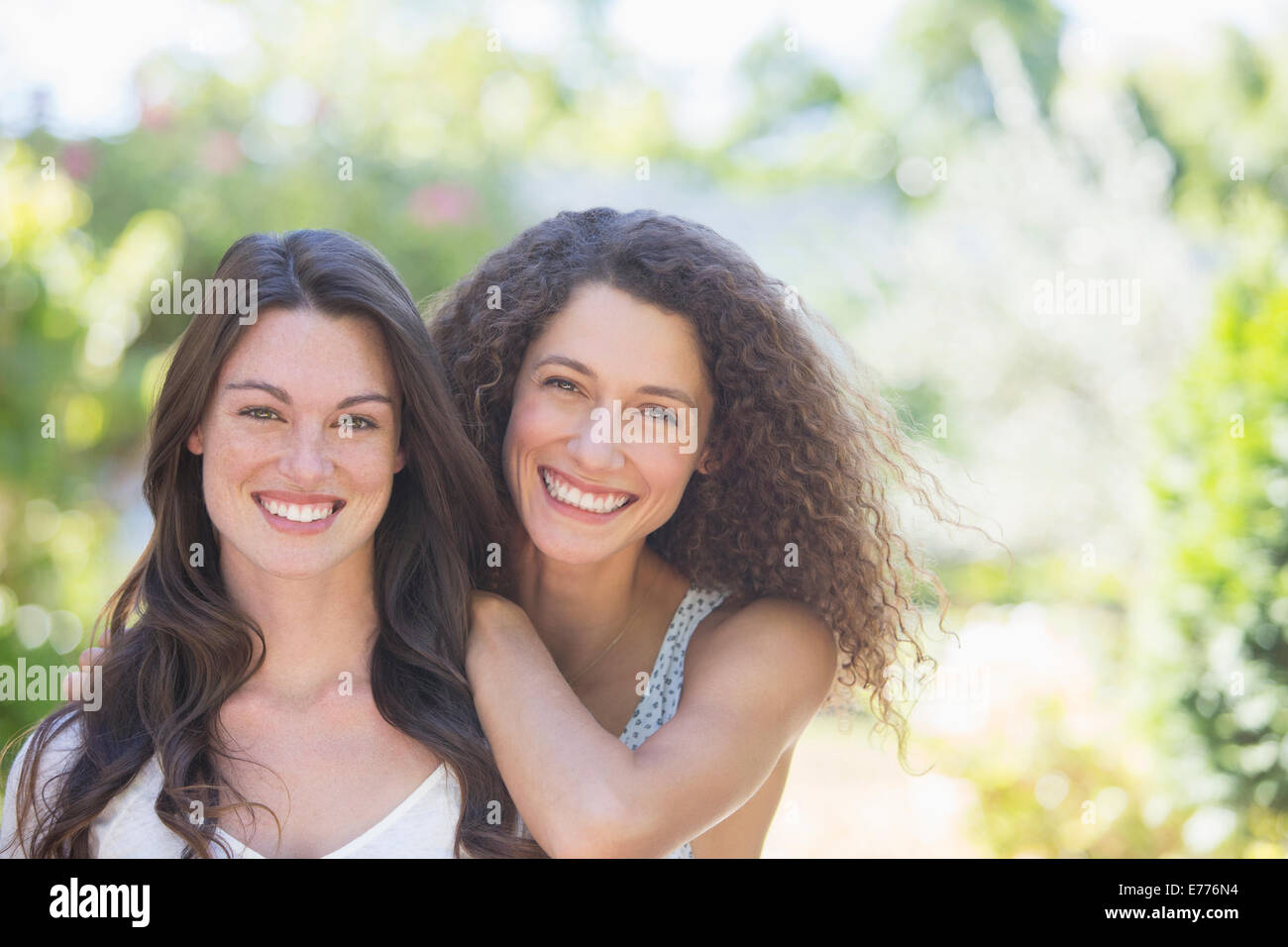 Sisters smiling together outdoors Stock Photo