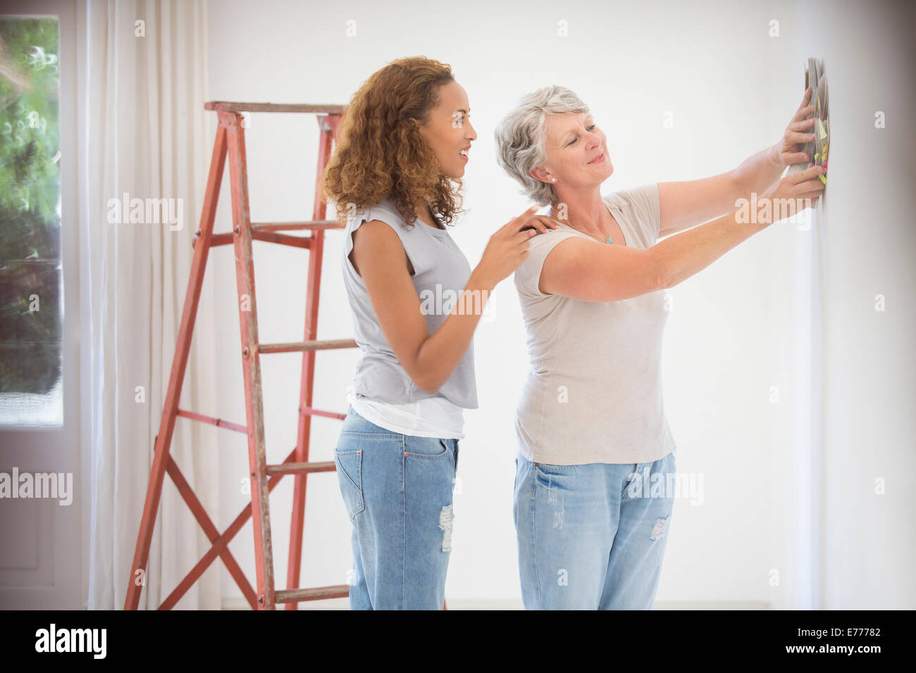 Two women deciding on wall color together Stock Photo