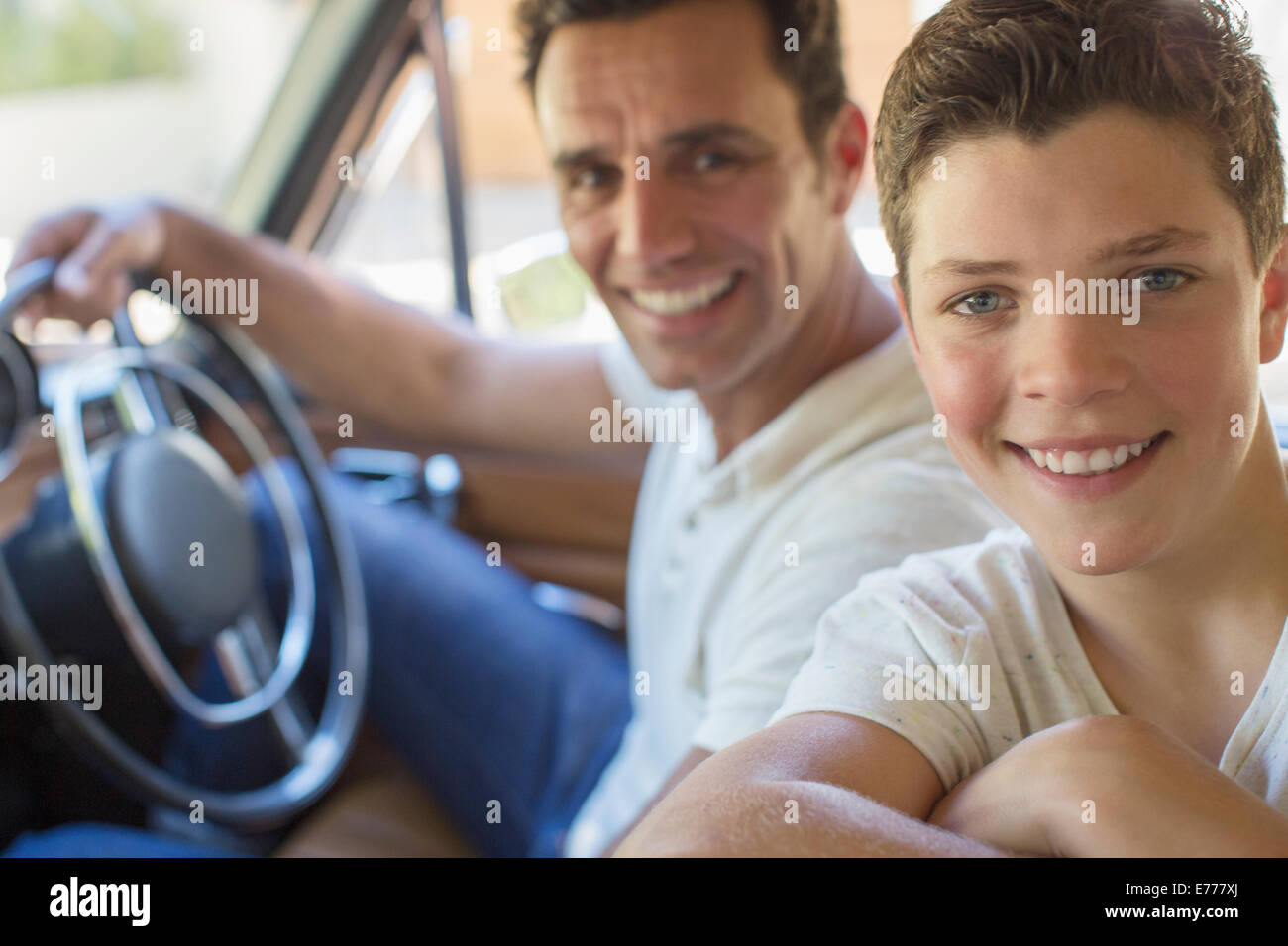 Father and son riding in car together Stock Photo