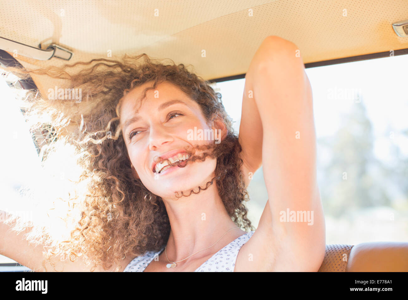 Woman being windswept from window breeze Stock Photo