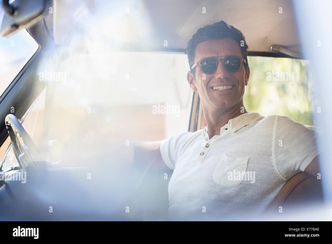 Man driving car on sunny day Stock Photo