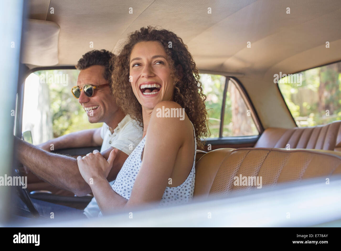 Couple laughing during car ride Stock Photo