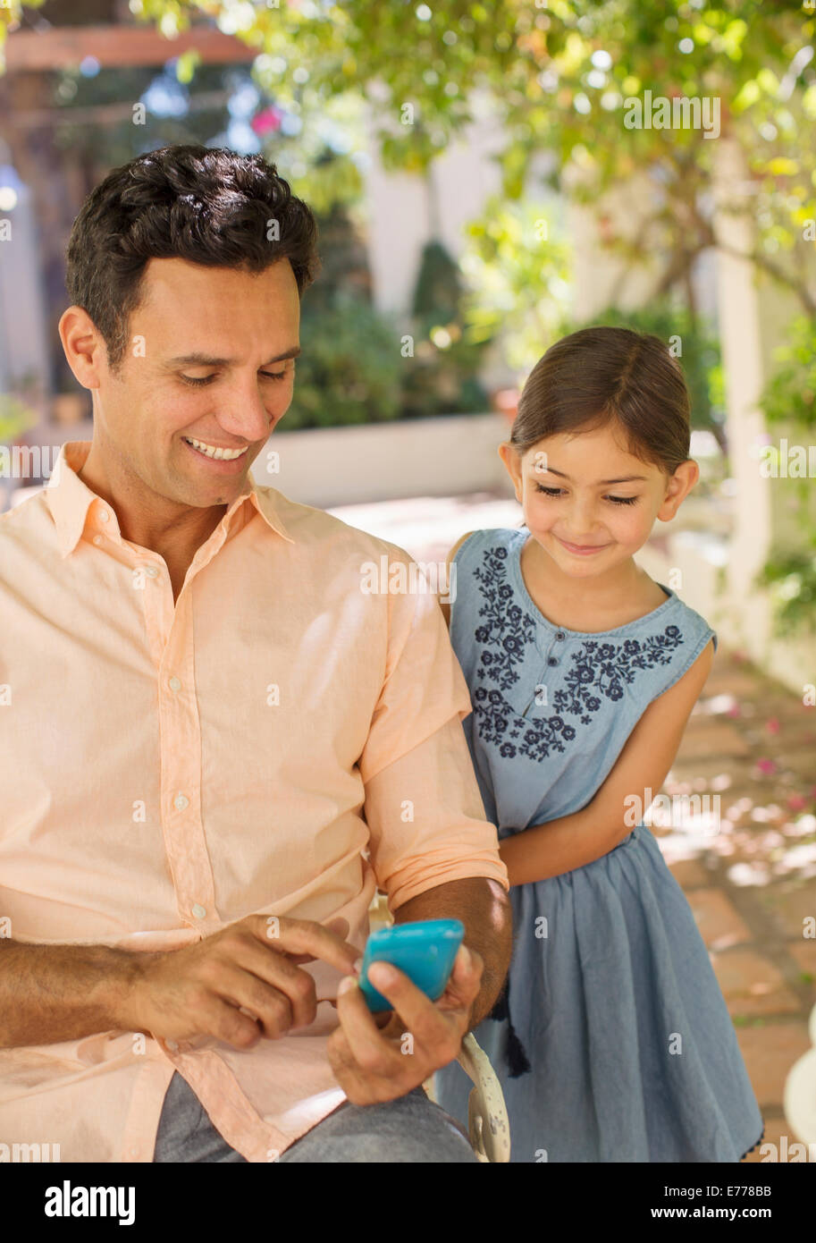 Father and daughter looking at cell phone Stock Photo