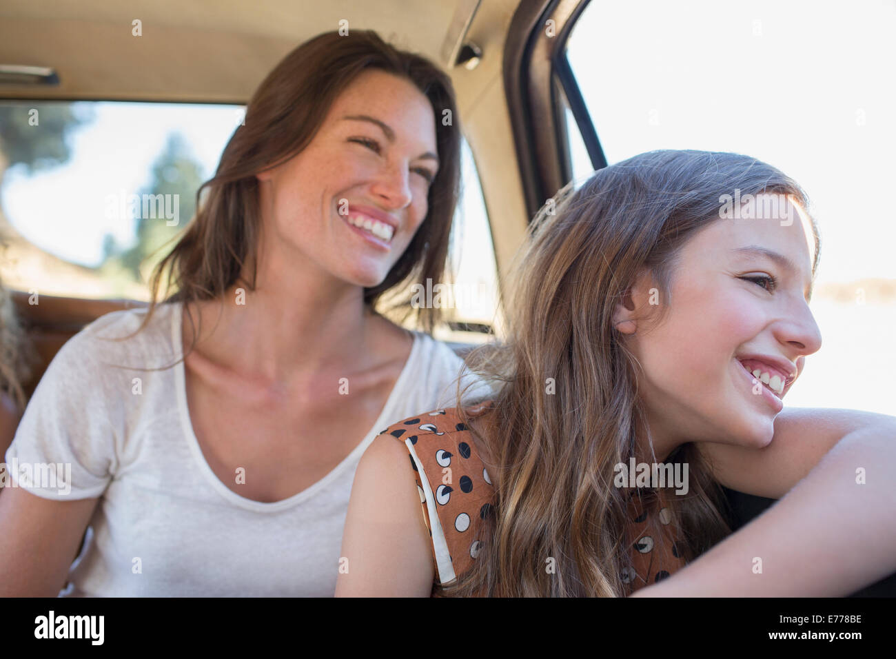 Sisters riding in car backseat together Stock Photo
