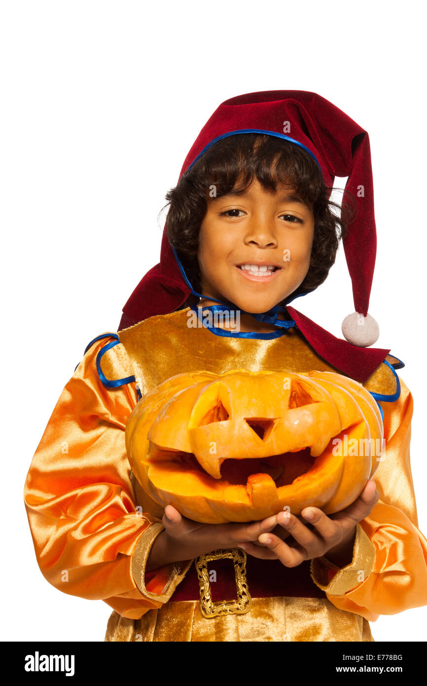 Boy in dwarf costume with carved pumpkin Stock Photo