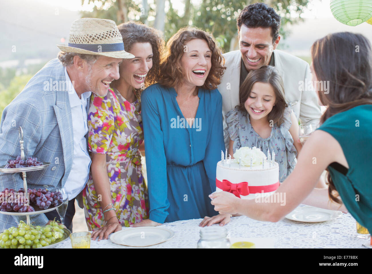 Family celebrating birthday with cake Stock Photo