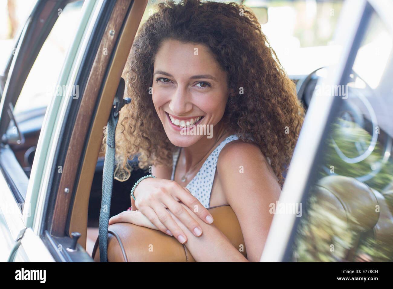 Woman riding in car on sunny day Stock Photo