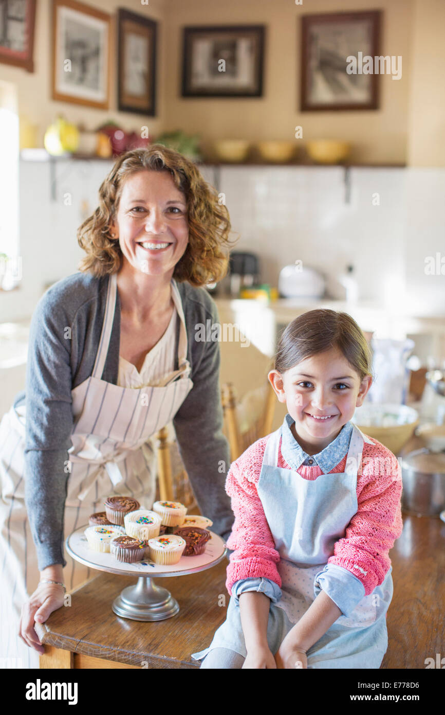 Grandmother and granddaughter smiling in kitchen Stock Photo