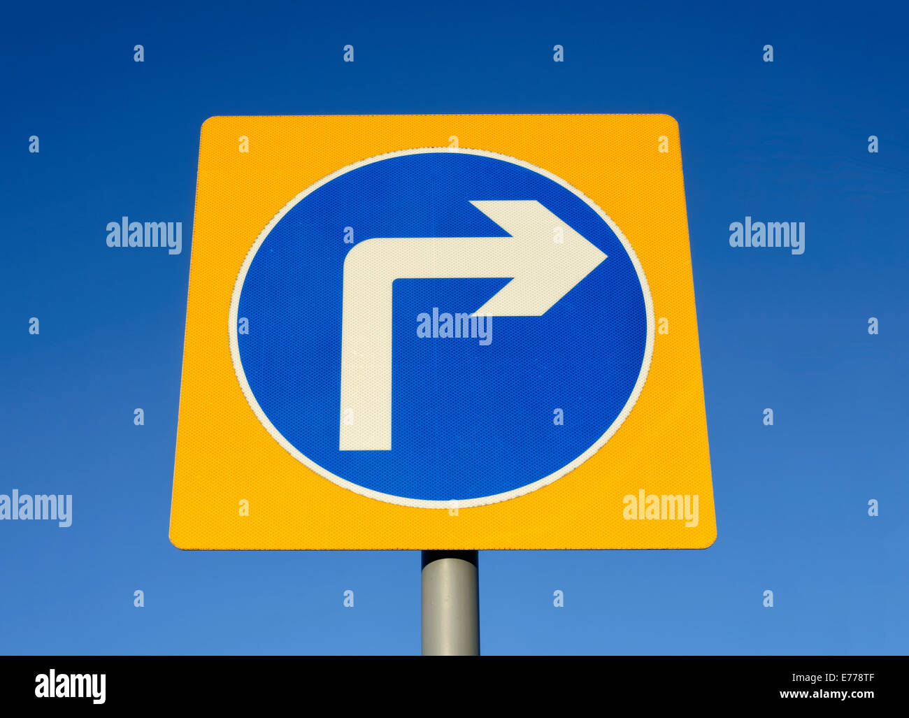 Turn right road sign set against a blue sky Stock Photo