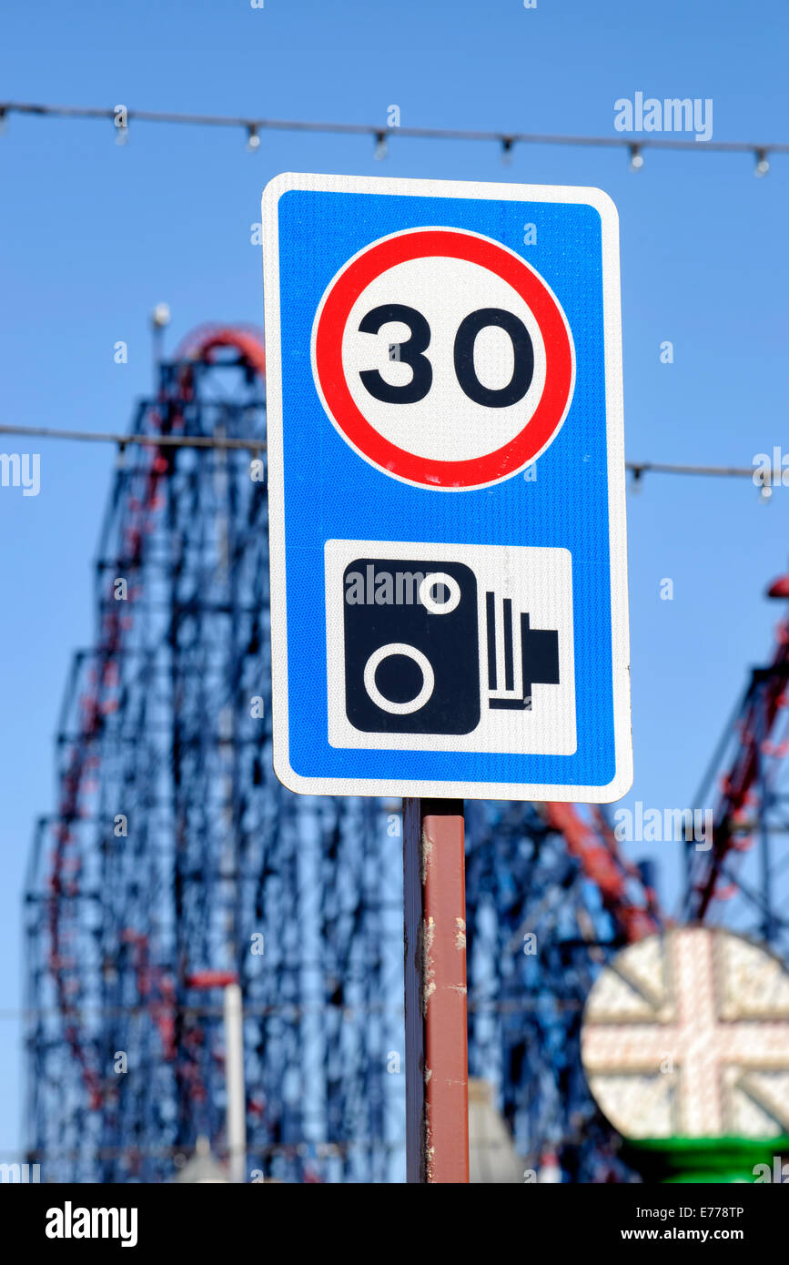 30 MPH speed limit and speed camera sign with 'The Big One' rollercoaster in the background (Blackpool, Lancashire) Stock Photo