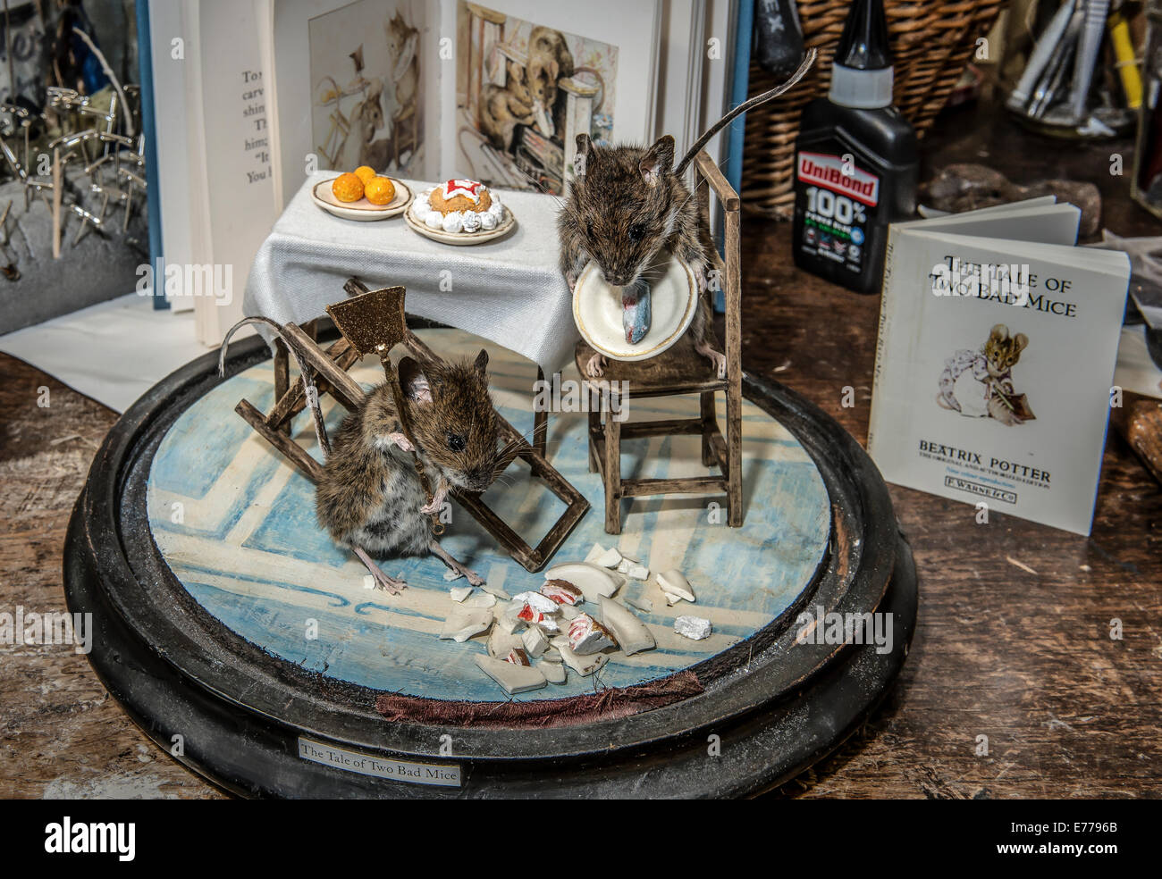 Taxidermy mice in tea party scene recreating Beatrix Potter story 'The Tale of Two Bad Mice' Stock Photo