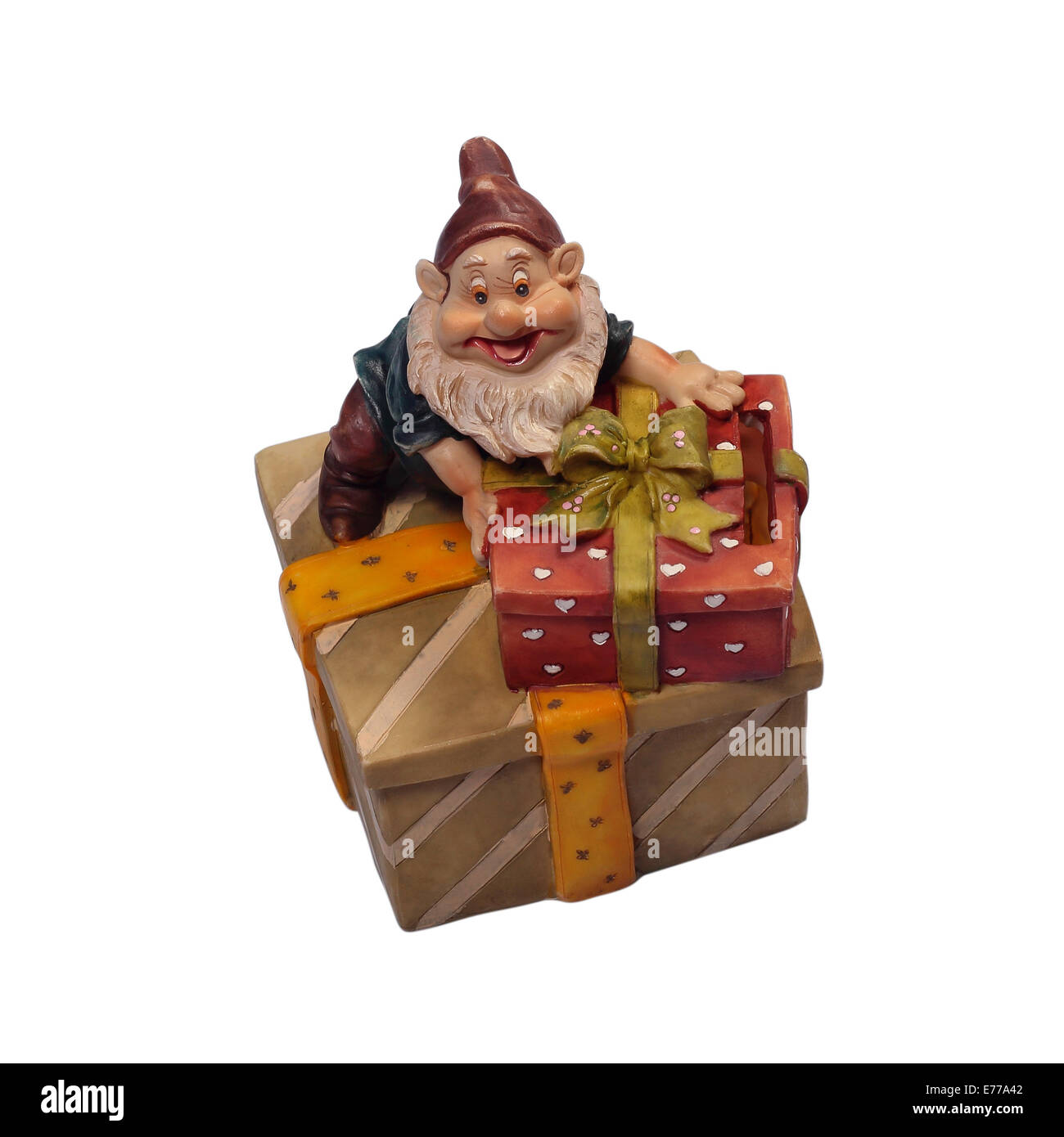 The gnome a moneybox with gifts on a white background. It is isolated, the worker of paths is present. Stock Photo