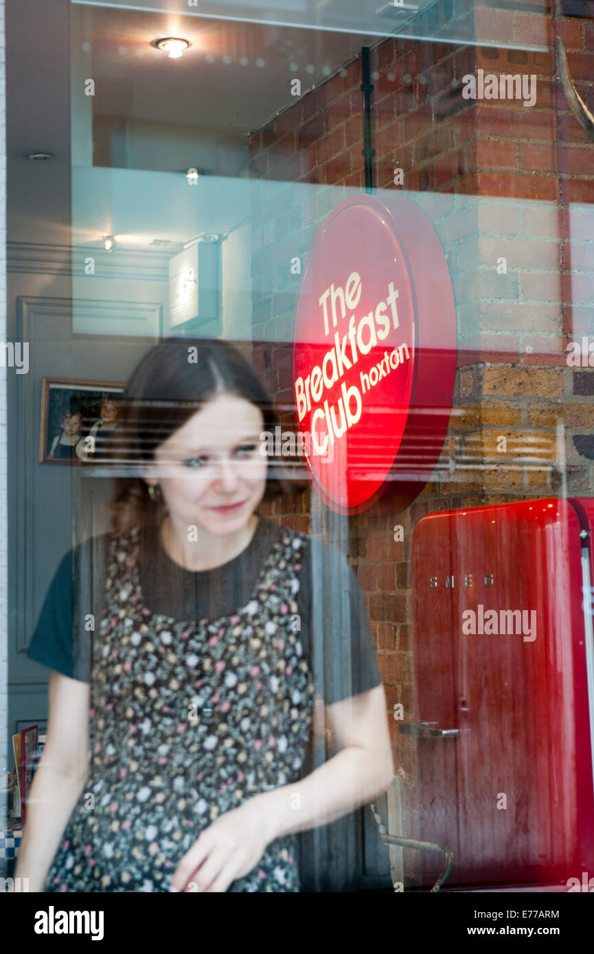 A waitress talking to costumers at the Breakfast Club, a diner and lounge off Hoxton Square in East London. Stock Photo